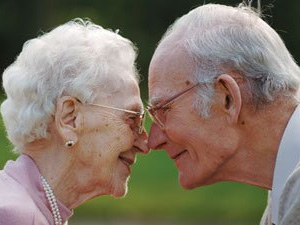 Elderly couple kissing
