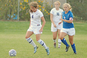 Girls playing youth soccer. Cropped from photo by Sarah Jones at flickr.com/photos/80778878@N00/1325427729