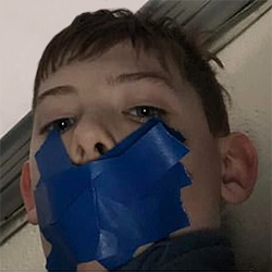 11-year-old Brady Webster with painters tape over his mouth