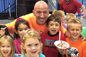 former NFL player and philanthropist Ricky Proehl with children participating in his POWER of Play program