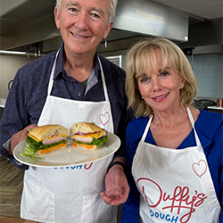 Actors Patrick Duffy and Linda Purl in aprons promoting Duffy&rsquo;s Dough